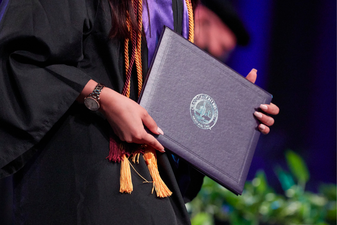 image of person holding diploma